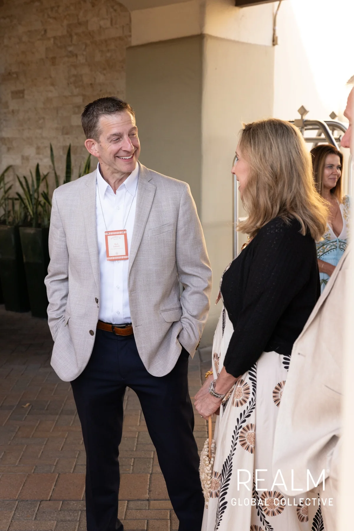 Rick Janson speaking with an attendee at REALM Global Collective in Scottsdale