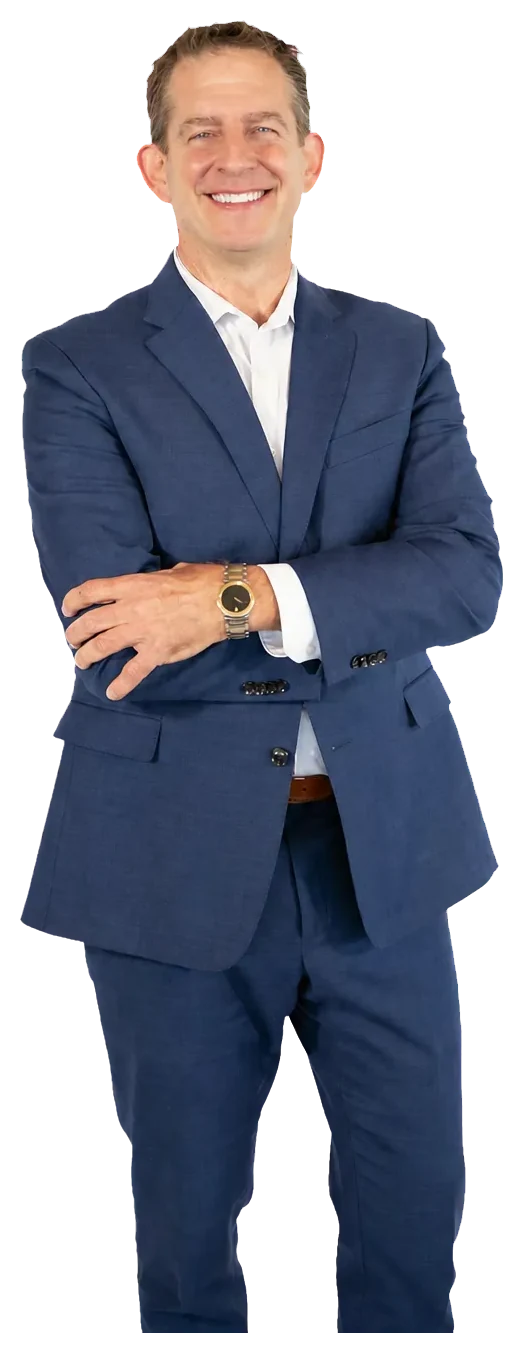 Rick Janson in a blue suit with his arms crossed