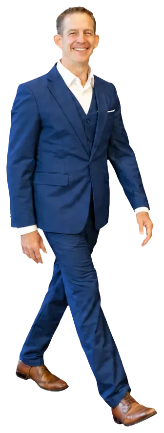Rick Janson walking in a navy three-piece suit